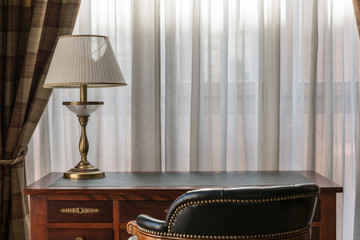 Table with lamp by the window