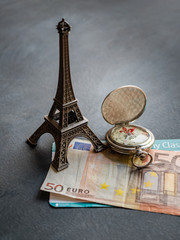 Eiffel tower with 50 euro banknote and boarding pass
