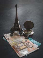 Eiffel tower with 50 euro banknote and boarding pass