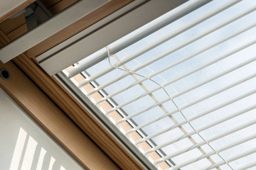Upper attic window with blinds