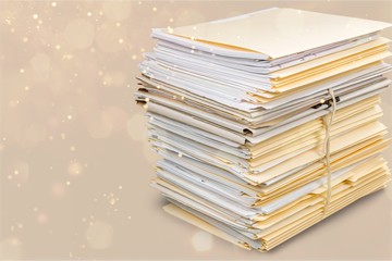 Stack of documents in folders isolated on white