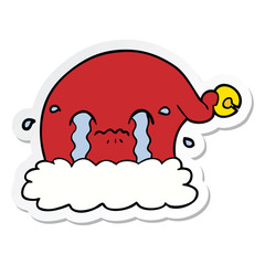 sticker of a cartoon christmas santa hat crying