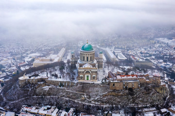 Esztergom, Hungary - Aerial view of the beautiful snowy Basilica of Esztergom on a foggy winter morning