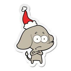 sticker cartoon of a unsure elephant wearing santa hat