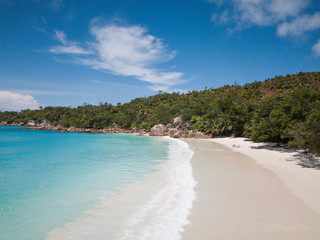  Beautiful beach in Seychelles aerial shot. Azure water and round granite stone, vacation in paradise