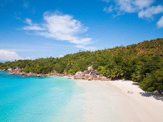 Fototapeta na wymiar Beautiful beach in Seychelles aerial shot. Azure water and round granite stone, vacation in paradise
