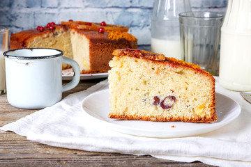 Big round semolina cake with caramelized sliced orange and berries , poured with berry syrup and sprinkled with orange zest