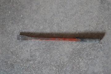 old vintage demolition tool bit isolated on gray cement background