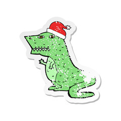 retro distressed sticker of a cartoon dinosaur in christmas hat