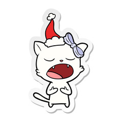 sticker cartoon of a cat meowing wearing santa hat