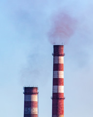 Smoke from pipes at the factory against the sky
