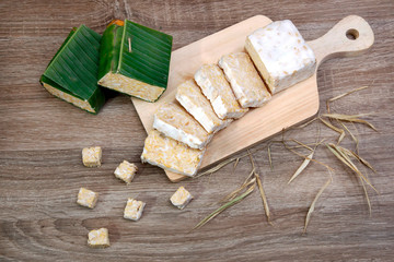 slices of raw tempeh on cutting board