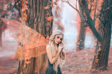 bright summer photo with shining rays of sun, mysterious forest fairy fell in love with prince, girl with puppet face, blond long hair and blue eyes, lady in green dress peeps modestly, with interest