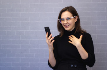 Young smiling woman is chatting on the phone