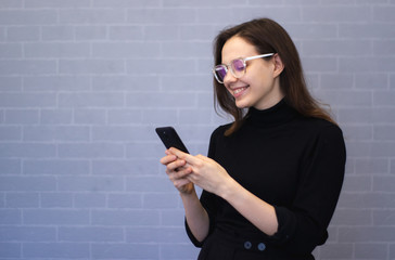 Young smiling woman is chatting on the phone