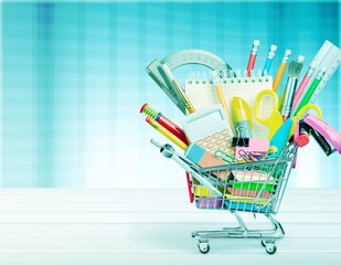 School stationery composition in shopping cart
