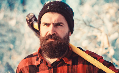 Bearded lumberjack. Male holds an ax on a shoulder. Brutal bearded man. Brutal bearded lumberjack...