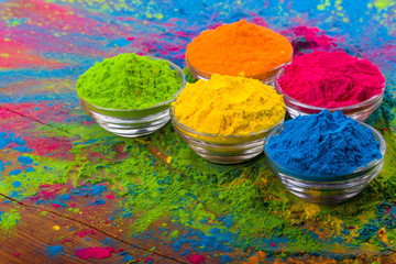 Holi color powder. Organic Gulal colours in bowl for Holi festival, Hindu tradition festive. Bright...