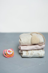 Colorful cotton folded clothes stack on white table empty space background,baby laundry.