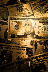 Currency US golden dollar banknotes close-up background.