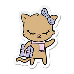 sticker of a cute cartoon cat with present