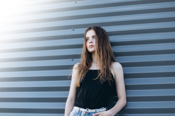 Cute cheerful portrait of young teenage girl outdoors in the street . Emotions, portrait, beauty concept