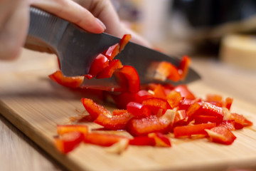Woman hands cutting vegetables in the kitchen