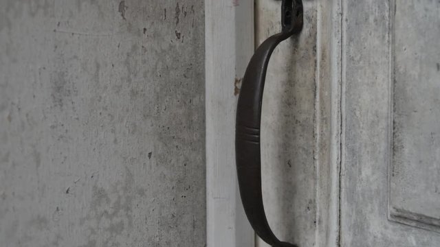 Old white colonial door close up on door handle