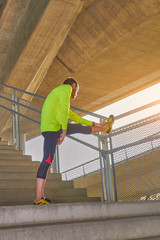 Sportsman working out / jogging on a big city urban bridge.