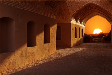 Iran. Neighborhood Yazd. Towers of silence. Sunset on the background of traditional architecture.
