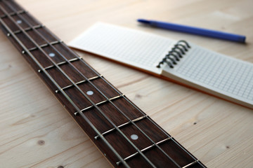 bass guitar and notepad