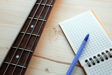 bass guitar and notepad