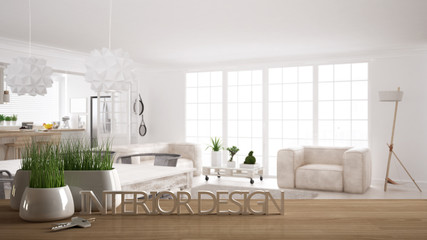 Wooden table, desk or shelf with potted grass plant, house keys and 3D letters making the words interior design, over blurred scandinavian living room, project concept background
