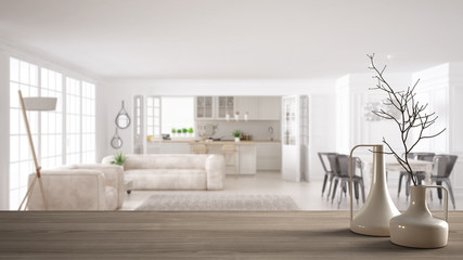 Wooden table top or shelf with minimalistic modern vases over blurred modern white kitchen and living room with sofa and big window, minimalist architecture interior design