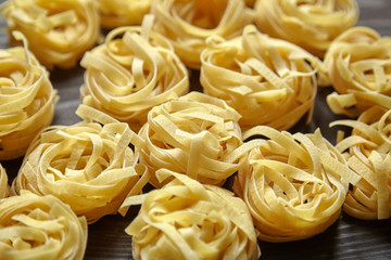 Tagliatelle italian pasta on brown wooden table