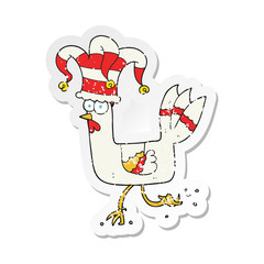 retro distressed sticker of a cartoon chicken running in funny hat