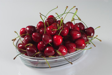 cherries on a plate on white background
