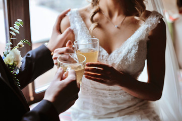 Groom and bride holding coffee cup. Cups of coffee for bride and groom at wedding day.