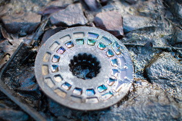 Oil creates iridescent colors on an old metal gear at the abandoned Furber's Scrapyard in Shropshire, England.