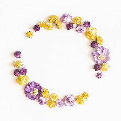 Flowers composition. Wreath made of purple and yellow flowers on white background. Flat lay, top view, copy space, square