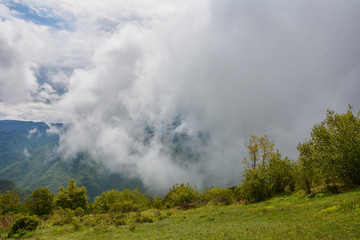 Spring landscape in Rhodope mountain, Bulgaria rainy puffy clouds 