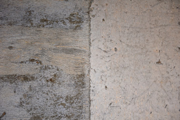 A fragment of a concrete wall with traces of plywood formwork and wood texture