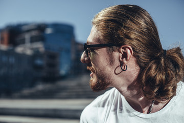 Handsome young man in sunglasses spending time outdoors