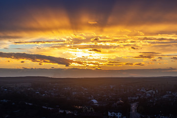 Clouds in the sunset sky over the village