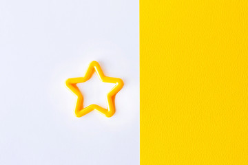 star on white and yellow background. Top view. Flat lay. Copy space for text