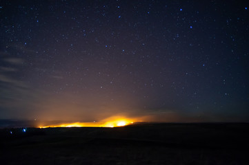 Burning grass in the field at night