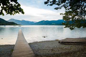 Picturesque view of wooden pier in the beach of Tegernsee lake near Gmund am Tegernsee in Germany