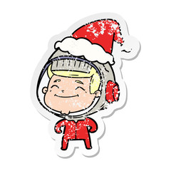 happy distressed sticker cartoon of a astronaut wearing santa hat