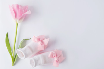 Table top view kids booties and flower for develop background concept.Flat lay.Design pastel tone...