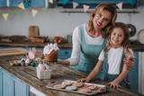 Mother and daughter posing with delicious bakery